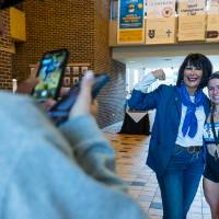 Person taking a picture of President Mantella and student runner.
